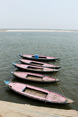 Small wooden boats parked by riverside, Varanasi, Uttar Pradesh, India