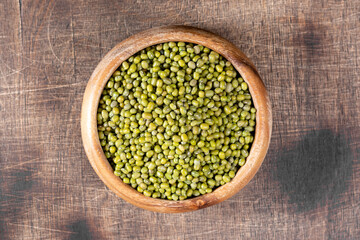 Mung. Green mung beans in a bowl on a brown wooden table. Legume plant for a healthy diet	