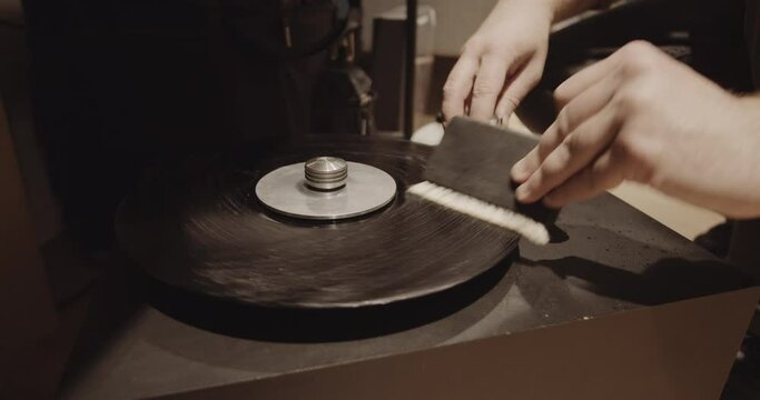 Washing dirty vinyl record with water solution and special cleaning technology in a music record store
