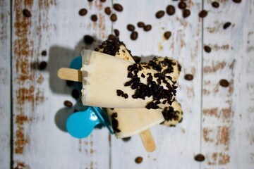 Coffee popsicles made of coconut milk, maple syrup and first-class espresso decorated with roasted crushed coffee beans.