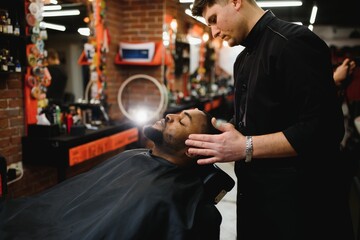 Visiting barbershop. African American man in a stylish barber shop