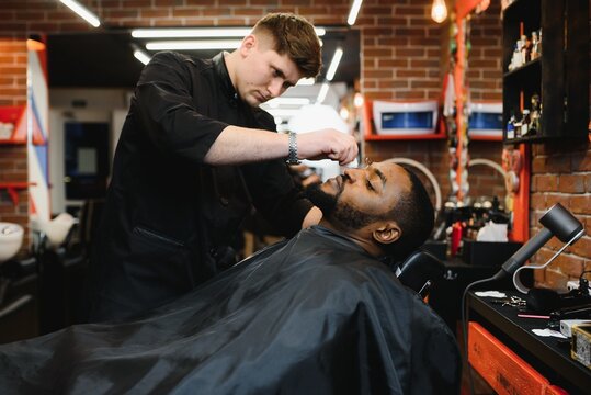 Visiting barbershop. African American man in a stylish barber shop