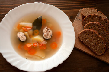 Fish soup from mackerel on white plate surved with bread. Hot food, home dish.