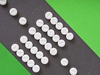 White pills are laid out in the form of a zebra crossing. The dark lane of the road symbolizes...
