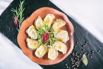 Dumplings with delicious meat on a plante. Dinner main dish on a wooden table. Traditional polish...