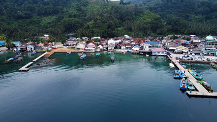 Pier with at Lampung Sea Pahawang Beach, located near the Sumatera city aerial drone. Resort Pahawang With a clouds on the Sky in a day. 