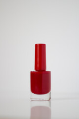 Red nail polish on a white background. Manicure.