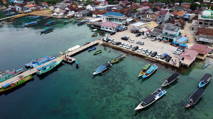 Fototapeta na wymiar Aerial view of top down picture of colorful wooden boats. Boats at the pier. 