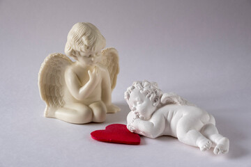 angel sitting and angel sleeping on the heart
