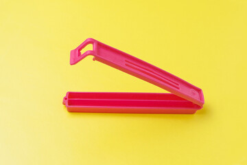 Plastic latch for household needs close-up on a yellow background
