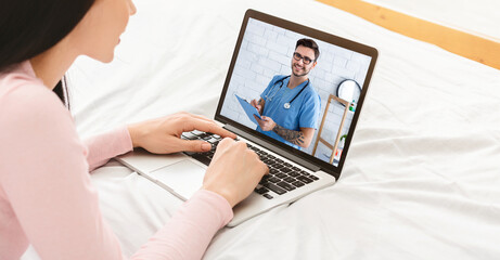Telehealth concept. Young woman having video conference with her doctor, consulting therapist online from home