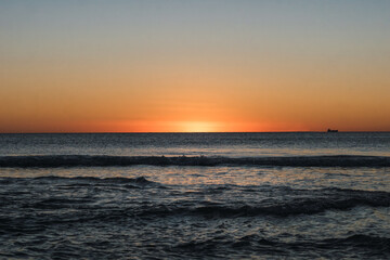 Last moment of the sun setting at sunset over the sea
