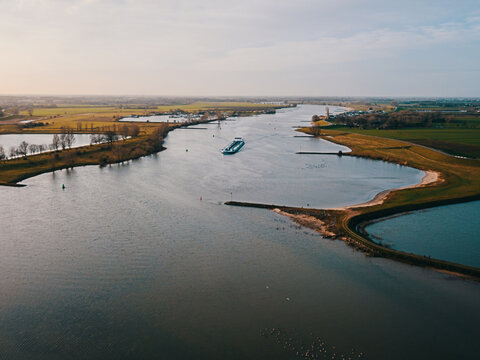 Aerial drone view of the ship passing at the canal in the Netherlands.