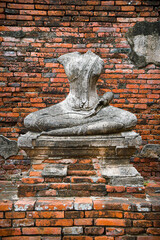 Headless stone Buddha statue