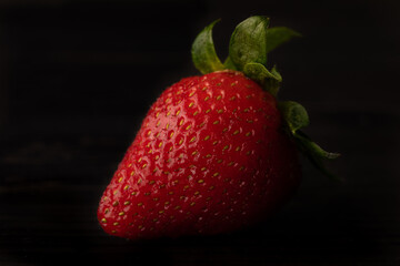 Macro photo of strawberry and black backgrounds