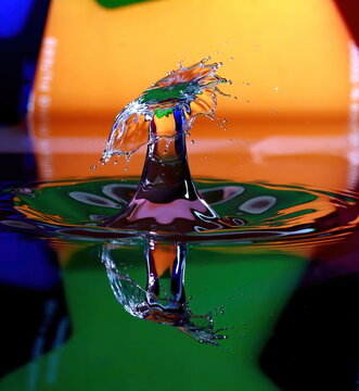 Macro high speed photography of Double impact water droplets with multi-color background.