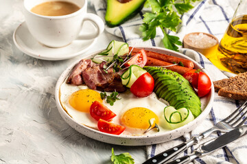 Traditional full English breakfast with fried eggs, sausages, beans, tomatoes and bacon on white background Top view