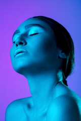 Proud. Beautiful east woman's portrait isolated on gradient studio background in neon, monochrome. Female brunette model. Concept of human emotions, facial expression, sales, ad, fashion and beauty.
