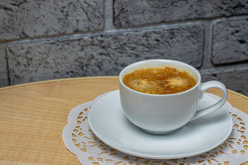 cup of coffee on a white saucer close-up