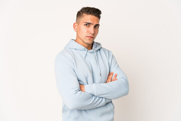 Young caucasian handsome man isolated suspicious, uncertain, examining you.