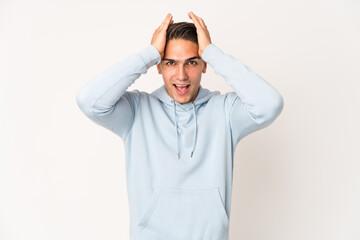 Young caucasian handsome man isolated screaming, very excited, passionate, satisfied with something.
