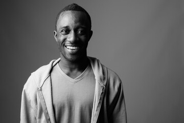 Portrait of young African man against gray background