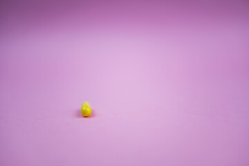 yellow pill on pink background