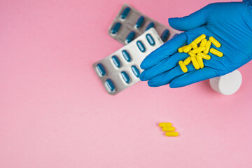 hand latex glove throwing yellow medicine pills