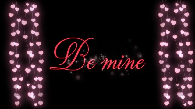 Animation of Be Mine written in red letters with two hearts garlands on black background
