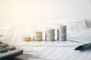 Stack of money coin on accounting sheet with selective focus, Business and financial concept. 