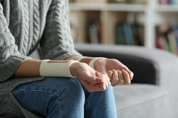 Woman with bandages on wrists after suicide attempt