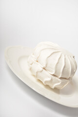 Side view of Russian organic marshmallow dessert zefir souffle served on plate isolated on light background. Dessert made of apple pectin, egg whites

