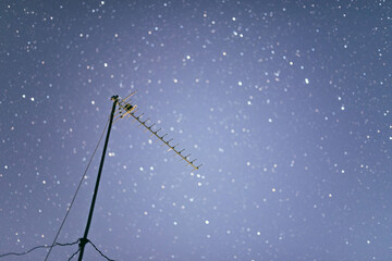 Obraz na płótnie Canvas satellite dish on blue sky stars background