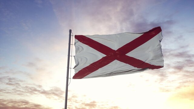 State flag of Alabama waving in the wind. Dramatic sky background. 3d illustration