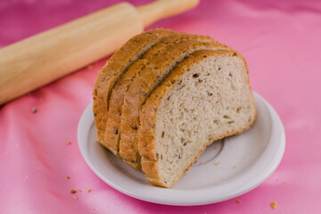 sliced bread with a rolling pin on the cloth