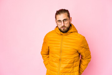 Young man with long hair look sad, serious face, feeling miserable and displeased.