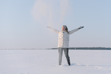 Woman playing with snow. Winter holiday