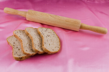 sliced bread with a rolling pin on the cloth