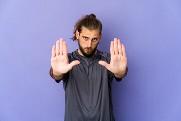 Naklejka premium Young man with long hair look points down with fingers, positive feeling.