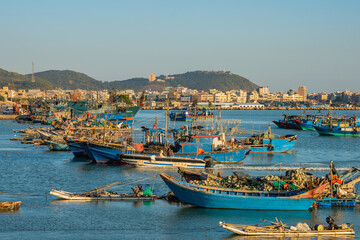 Fototapeta na wymiar The fishing boats in the bay at Nan'ao Island, Guangdong province, China, at sunset.