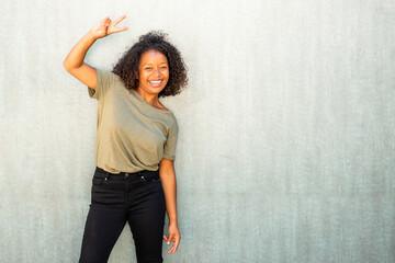 happy young woman with peace hand sign