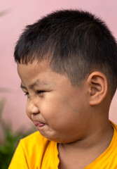 Obraz premium The boy made his face and mouth distorted by eating citrus fruits.
