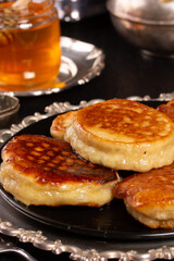 Fresh delicious pancakes lie in a metal dish