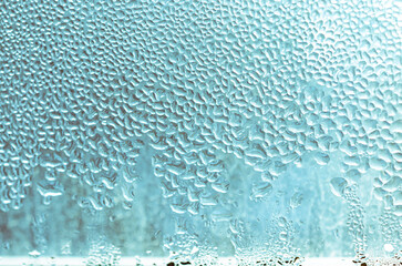 Large drops of condensate on a metal-plastic window. Dew point. Plastic