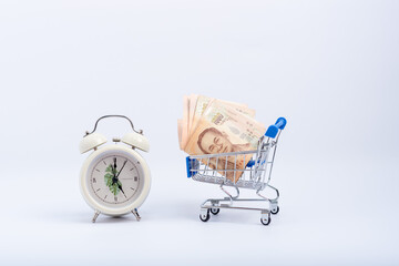 Thai banknotes are empty on the cart And there is a clock telling the time next to it / an...