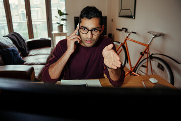 Mixed race business man chatting to colleague explaining concepts while working from home office