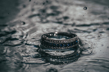 the ring lies in the water on a mirror surface