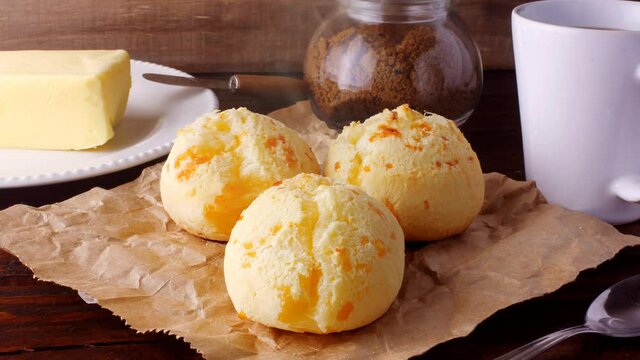 homemade cheese bread, traditional Brazilian snack, on the breakfast table in a rustic farm kitchen