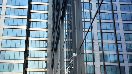 Fototapeta premium Concept for real estate and corporate construction..The modern office building of the orange morning sun in the sky background.