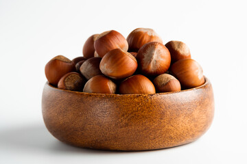 a handful of nuts in a wooden plate
